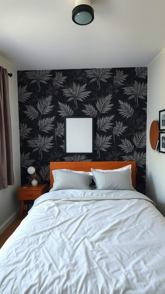 A small bedroom with a striking black and white fern-patterned accent wall, bright bedding, and modern furniture.
